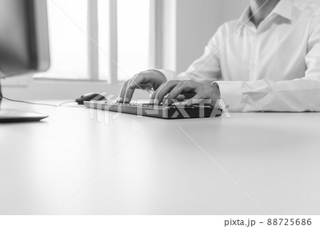 Businessman typing on computer keyboard Businessman typing on computer keyboard 88725686