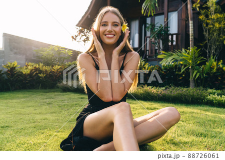 Joyful woman relaxing on lawn Joyful woman relaxing on lawn 88726061
