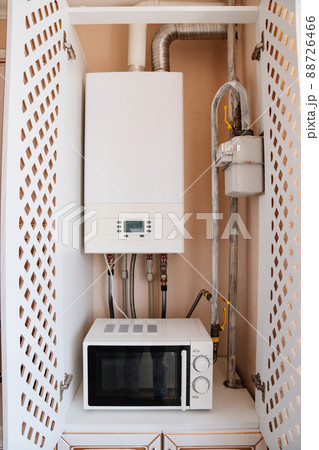 gas heating boiler and microwave in the kitchen cabinet. gas heating boiler and microwave in the kitchen cabinet. 88726466