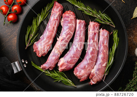 Bird chicken giblets gizzards stomachs, on old dark rustic table background, top view flat lay Bird chicken giblets gizzards stomachs, on old dark rustic table background, top view flat lay 88726720