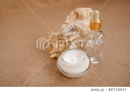 Caring cosmetics in an oyster shell on the sand. Eco-friendly organic cosmetics. Caring cosmetics in an oyster shell on the sand. Eco-friendly organic cosmetics. 88728047