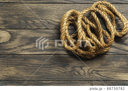 Rolled rope on oak table with copy space Rolled rope on oak table with copy space 88730782