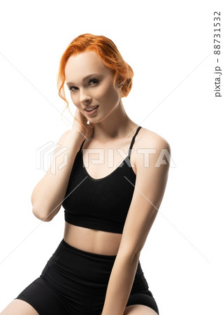 Smiling young sportswoman in black sportswear look at camera Smiling young sportswoman in black sportswear look at camera 88731532