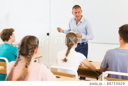 Teacher conducting lesson for teenage schoolchildren in classroom Teacher conducting lesson for teenage schoolchildren in classroom 88733029
