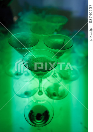 Glasses of champagne with dry ice. Champagne slide. Pyramid or fountain made of champagne glasses Glasses of champagne with dry ice. Champagne slide. Pyramid or fountain made of champagne glasses 88740557