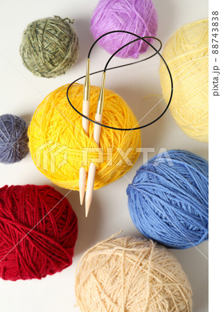 Balls of yarn with knitting needles on white background Balls of yarn with knitting needles on white background 88743838