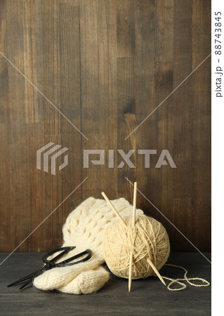 Concept of knitting with yarn ball on gray wooden table 88743845