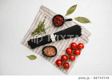 Black colored spaghetti raw dry, on white stone table background, top view flat lay 88744548