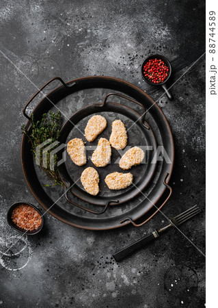 Raw chicken nuggets meat set, on black dark stone table background, top view flat lay 88744589
