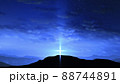 Bright cross on the hill with clouds moving on the blue starry sky 88744891