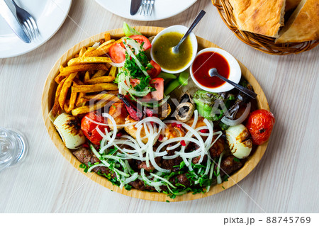 Kebab, barbecue, vegetables, tkemali, sauce, tomatoes, peppers.  88745769