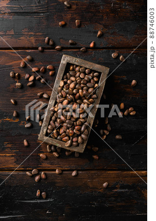 Pine wild organic nut, on old dark wooden table background, top view flat lay Pine wild organic nut, on old dark wooden table background, top view flat lay 88746003