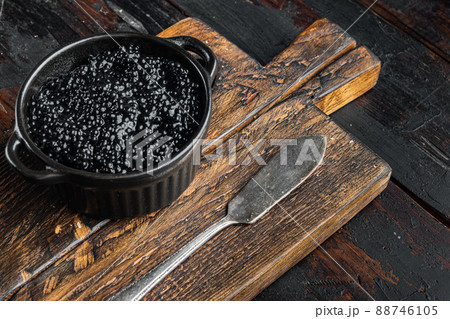 Black sturgeon caviar, on old dark wooden table background 88746105
