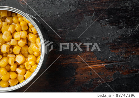 Canned sweet corn, on old dark wooden table background, top view flat lay with copy space for text 88747396