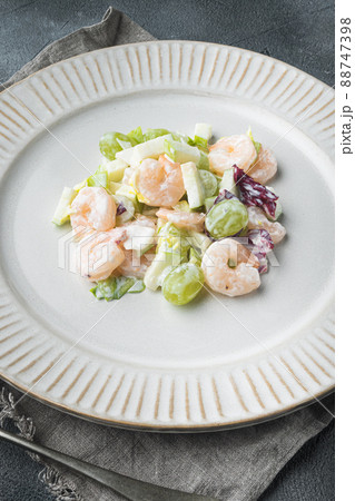 Prawn cocktail with lettuce, cherry tomatoes, dressing, dill , with sauce apple and grape, on gray background 88747398