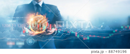 Hands of businessman and gold bitcoin coin in fire with volatile business graph on global network, Financial, Stock market, Cryptocurrency and investment. 88749196
