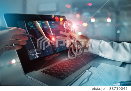 Medicine doctor team meeting and analysis. Diagnose checking osteoarthritis knee testing result with modern virtual interface on laptop, Joint ache problems, Medical technology network. 88750045