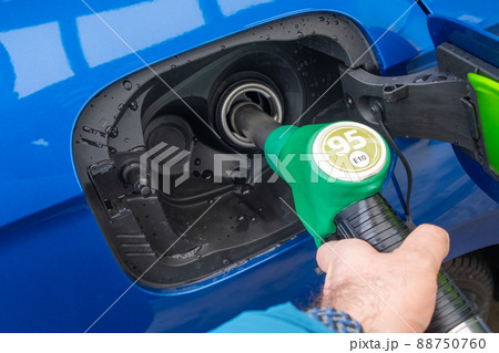 Man refuels a car with gasoline. Rise in fuel prices. Sanctions against Russia and the oil embargo concept.  88750760