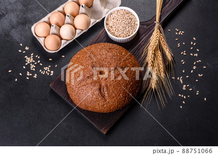 Fresh baked brown bread with ears and grains of wheat 88751066