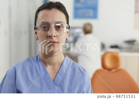 Closeup of stomatologist nurse working at stomatological treatment in dentistry medical office during dentistry examination. Medical team analyzing teeth radiography. Medicine services Closeup of stomatologist nurse working at stomatological treatment in dentistry medical office during dentistry examination. Medical team analyzing teeth radiography. Medicine services 88751531