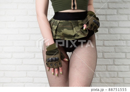 slender body of a girl in military gloves and a short sexy short skirt close-up slender body of a girl in military gloves and a short sexy short skirt close-up 88751555