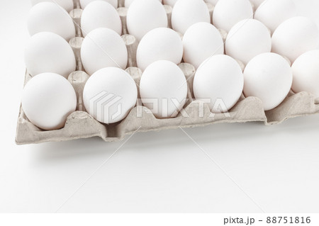 Fresh raw 30 pack of large eggs white eggs in cardboard. Consumerism, egg production concept Fresh raw 30 pack of large eggs white eggs in cardboard. Consumerism, egg production concept 88751816