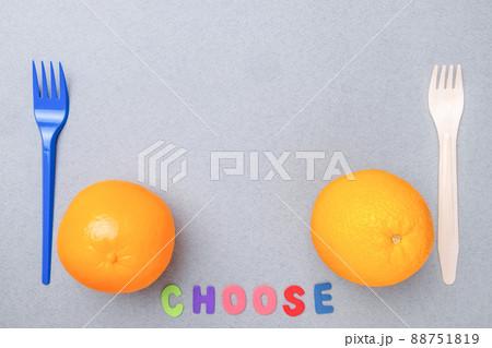 Plastic fork, plastic toy orange, wooden fork and natural orange. Flat lay. Plastic fork, plastic toy orange, wooden fork and natural orange. Flat lay. 88751819
