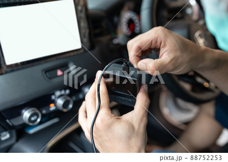 Hand of technician preparing and installing front camera car recorder 88752253