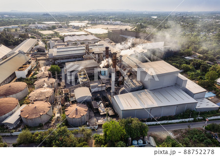 Aerial view of sugar processing plant with pollution smoke from chimney and tank warehouse in agricultural industrial factory 88752278