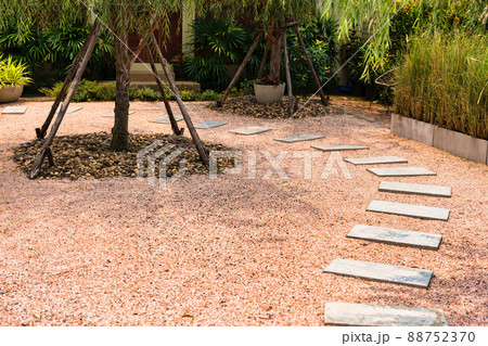 Zen stone path on gravel floor in the garden Zen stone path on gravel floor in the garden 88752370
