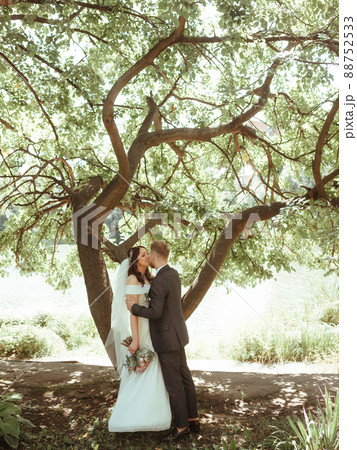Happy wedding couple walking in a botanical park grain effect authentic 88752533