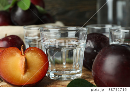 Concept of alcohol with plum vodka, close up Concept of alcohol with plum vodka, close up 88752716
