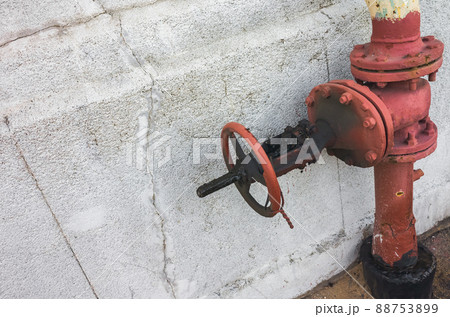 Blocked red gas valve mounted near gray concrete wall, close up Blocked red gas valve mounted near gray concrete wall, close up 88753899