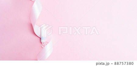 Tampon woman feminine hygiene. Pink ribbon with menstrual tampon on pink background. Menstruation feminine period. Soft tender protection for women critical days. Tampon woman feminine hygiene. Pink ribbon with menstrual tampon on pink background. Menstruation feminine period. Soft tender protection for women critical days. 88757380