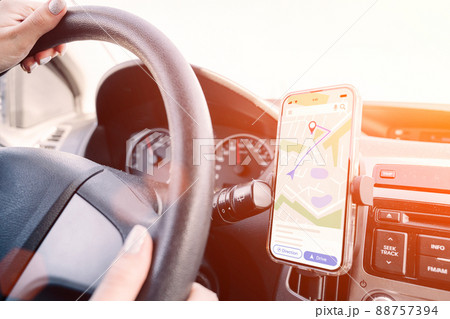 Navigation auto map system GPS. Global positioning system on smartphone screen in auto car on travel road. GPS navigation with smartphone application system. Navigation auto map system GPS. Global positioning system on smartphone screen in auto car on travel road. GPS navigation with smartphone application system. 88757394