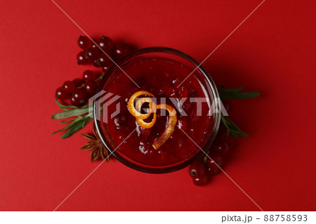 Cranberry sauce and ingredients on red background Cranberry sauce and ingredients on red background 88758593