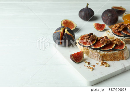 Concept of tasty food with bruschetta with fig on white wooden table 88760093