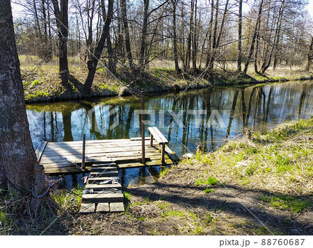 Wooden raft on small stream in wood 88760687