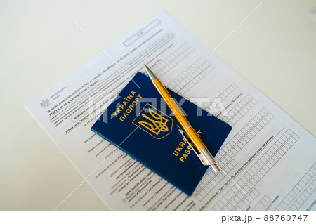 PESEL document, Ukrainian passport and a pen on white table background. PESEL document, Ukrainian passport and a pen on white table background. 88760747