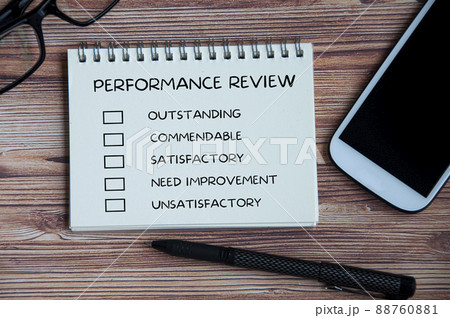 Performance appraisal checklist on notepad with with office setting background. 88760881