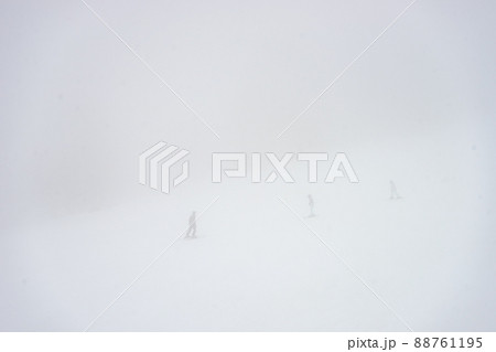 Skiers on the slopes in misty day Skiers on the slopes in misty day 88761195