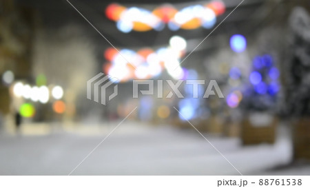 Blurred background of snowy city street, Christmas trees illumination decoration Blurred background of snowy city street, Christmas trees illumination decoration 88761538