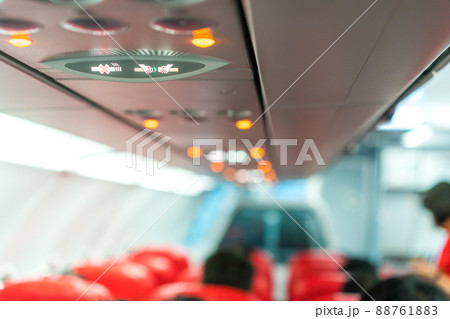 closeup airplane Console panel; lamp, light, need help button, air condition, sefty belt and no smoking lighting sign. closeup airplane Console panel; lamp, light, need help button, air condition, sefty belt and no smoking lighting sign. 88761883