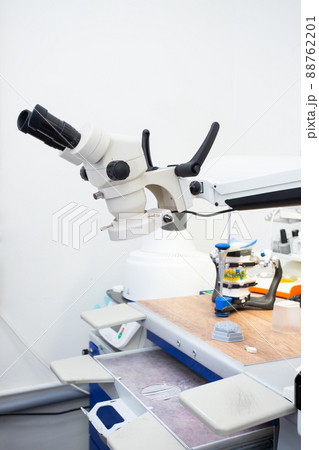 Microscope in a dental laboratory, a technician's workplace in a dental laboratory Microscope in a dental laboratory, a technician's workplace in a dental laboratory 88762201