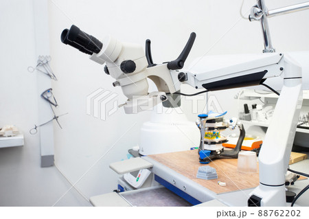 Microscope in a dental laboratory, a technician's workplace in a dental laboratory Microscope in a dental laboratory, a technician's workplace in a dental laboratory 88762202