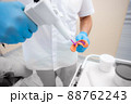 Dentist prepares material for a mold of teeth. Close-up of a dentist in blue gloves 88762243