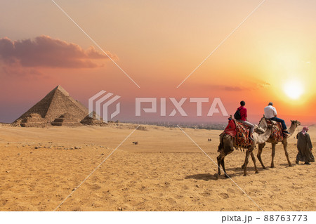 The Pyramid complex of Giza and arabs on camels, Egypt 88763773