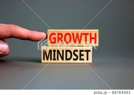 Growth mindset symbol. Wooden blocks with concept words Growth mindset on beautiful grey background. Businessman hand. Business growth mindset concept. Copy space. Growth mindset symbol. Wooden blocks with concept words Growth mindset on beautiful grey background. Businessman hand. Business growth mindset concept. Copy space. 88764091