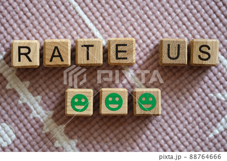 Rate us inscription on cubes and green smiling emoticons Rate us inscription on cubes and green smiling emoticons 88764666