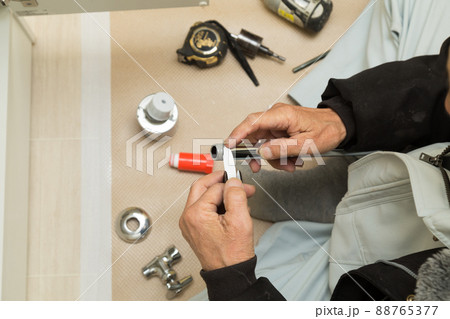 配管接続する職人手元 88765377